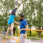 man-helping-woman-doing-handstand-2024-10-18-03-51-30-utc_Easy-Resize.com