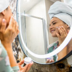 smiling-woman-applies-facial-cream-in-her-bathroom-2025-01-29-12-30-37-utc_Easy-Resize.com